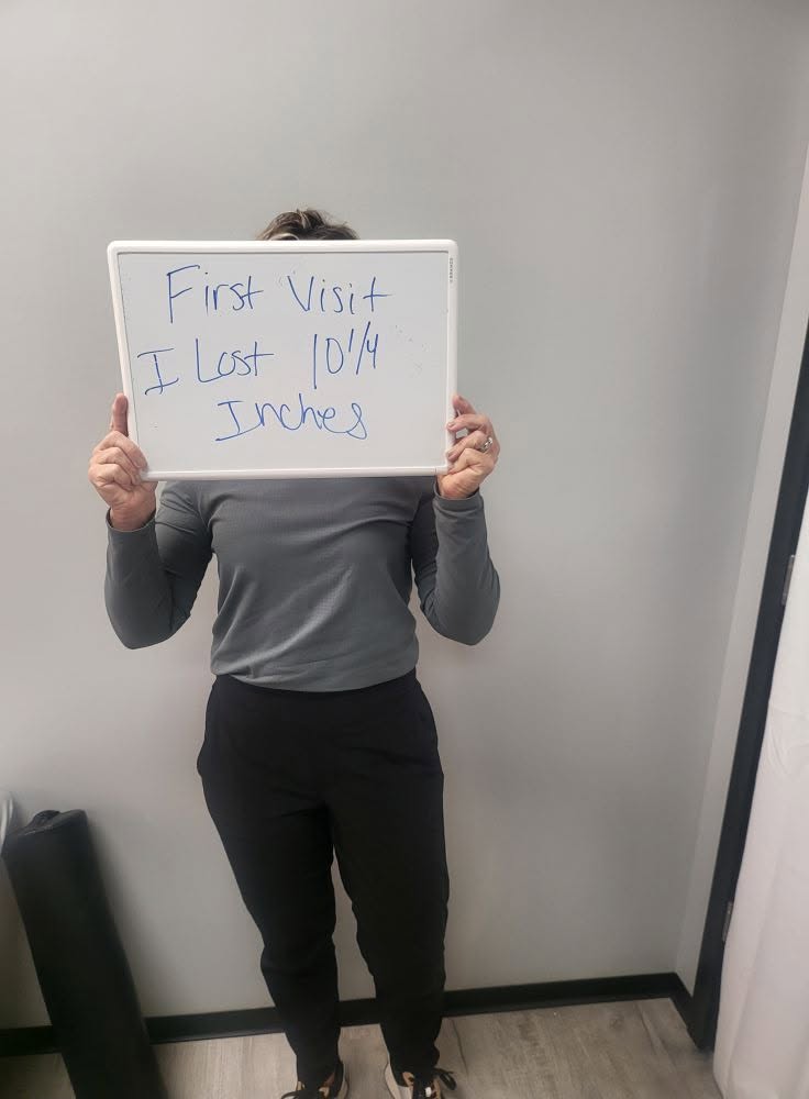 Contour Light client holding a whiteboard: 10¼ inches — Lost on her first visit